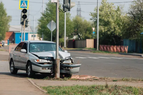 Single vehicle accident damage from pole impact
